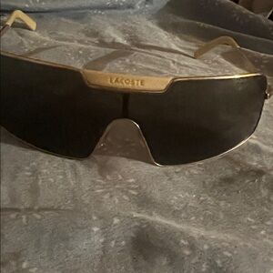 Lacoste Gold Rim Shield Sunglasses with Black Lenses